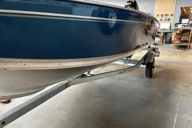 Slide: The Image of 2023 Lund 1600 Fury SS boat on trailer in garage setting. - 4