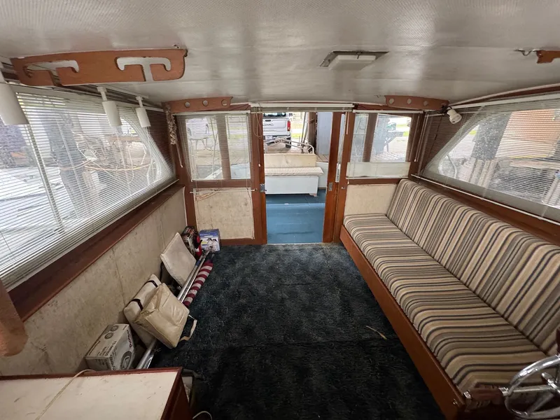 Slide: The Image of 1963 Hatteras Sport Fisherman interior with striped seating and carpeted floor. - 14