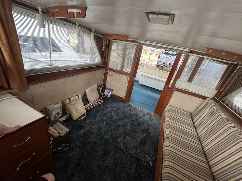 Slide: The Image of Interior of a 1963 Hatteras Sport Fisherman boat with striped seating and carpeted floor. - 15