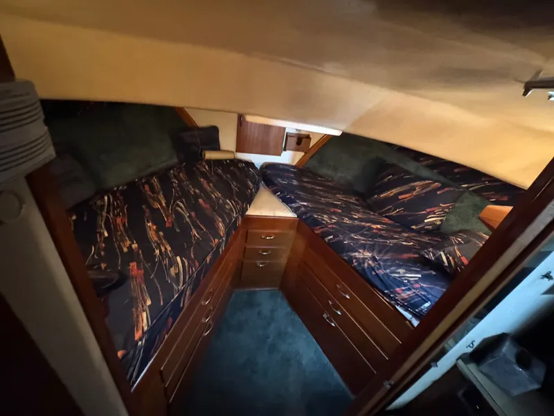 Slide: The Image of 1963 Hatteras Sport Fisherman cabin with twin beds and wooden storage drawers. - 16