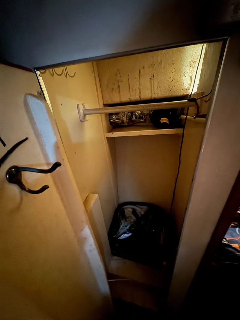 Slide: The Image of Small storage closet inside a 1963 Hatteras Sport Fisherman boat. - 17