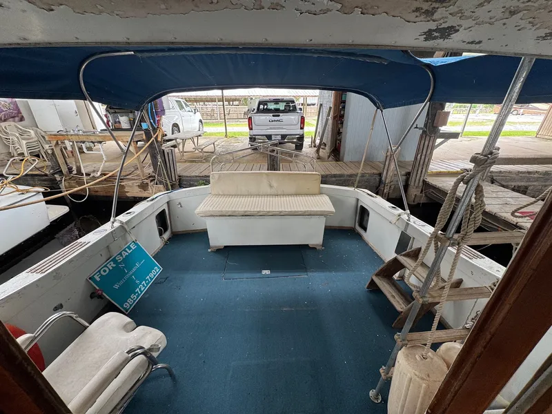 Slide: The Image of 1963 Hatteras Sport Fisherman boat interior with blue carpet and seating, for sale sign visible. - 4