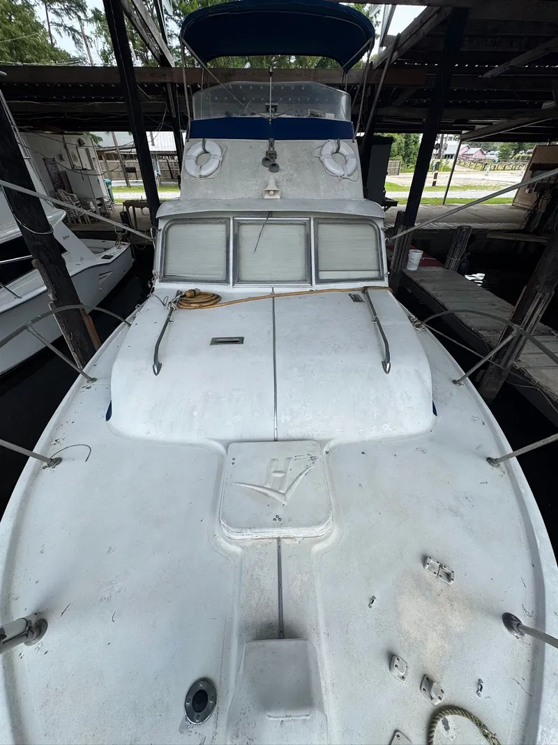 Slide: The Image of 1963 Hatteras Sport Fisherman boat docked in a covered marina. - 5