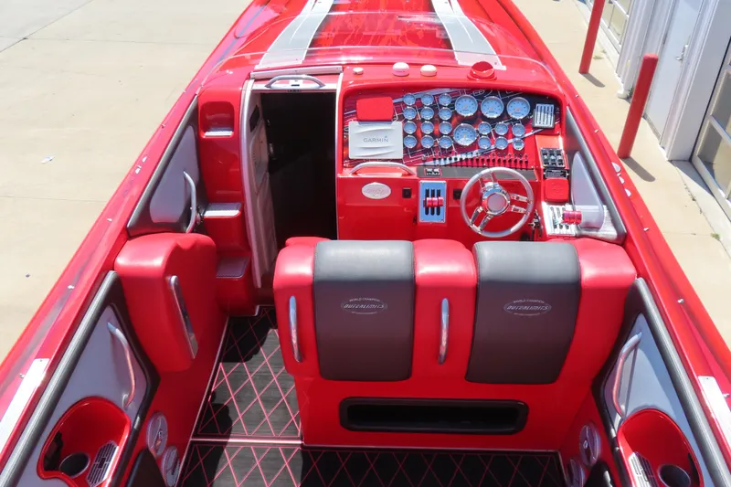 Slide: The Image of 2004 Outerlimits 42 Legacy boat interior with red and black seating, detailed dashboard. - 16
