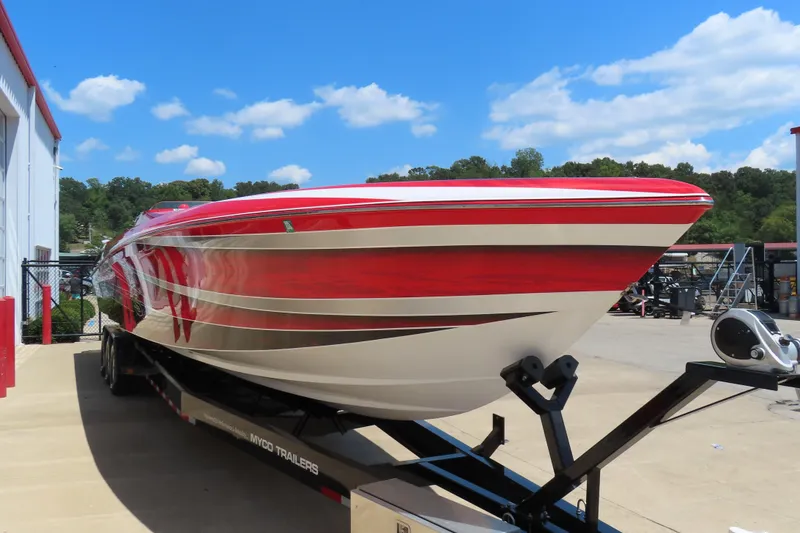 Slide: The Image of 2004 Outerlimits 42 Legacy speedboat with red and white design on a trailer. - 2