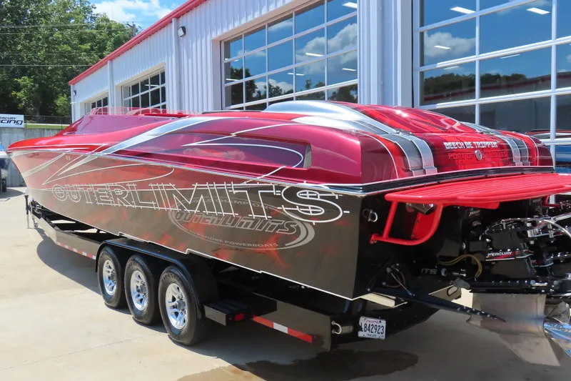 Slide: The Image of 2004 Outerlimits 42 Legacy powerboat with vibrant red and black design on a trailer. - 26