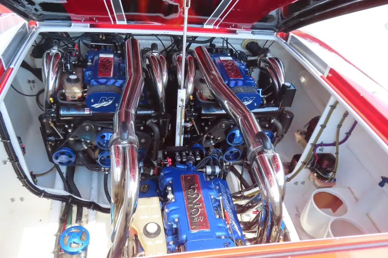 Slide: The Image of Engine compartment of a 2004 Outerlimits 42 Legacy boat with dual high-performance engines. - 3