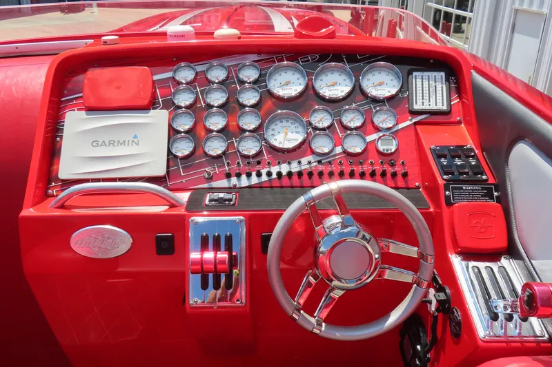 Slide: The Image of Red dashboard of 2004 Outerlimits 42 Legacy boat with gauges and Garmin navigation. - 31