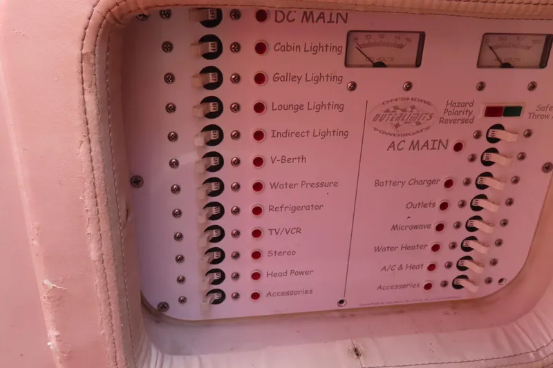 Slide: The Image of Control panel of a 2004 Outerlimits 42 Legacy powerboat, featuring various electrical switches. - 33
