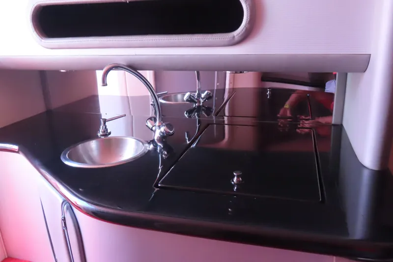 Slide: The Image of 2004 Outerlimits 42 Legacy yacht interior with sleek black countertop and modern sink. - 35