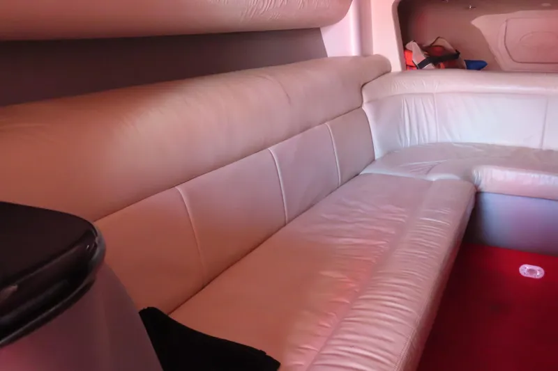 Slide: The Image of Interior of 2004 Outerlimits 42 Legacy boat with beige leather seating and red carpet. - 38