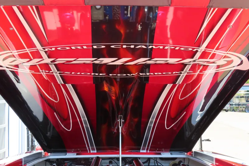 Slide: The Image of 2004 Outerlimits 42 Legacy powerboat with vibrant red and black design, showcasing "World Champion" branding. - 9