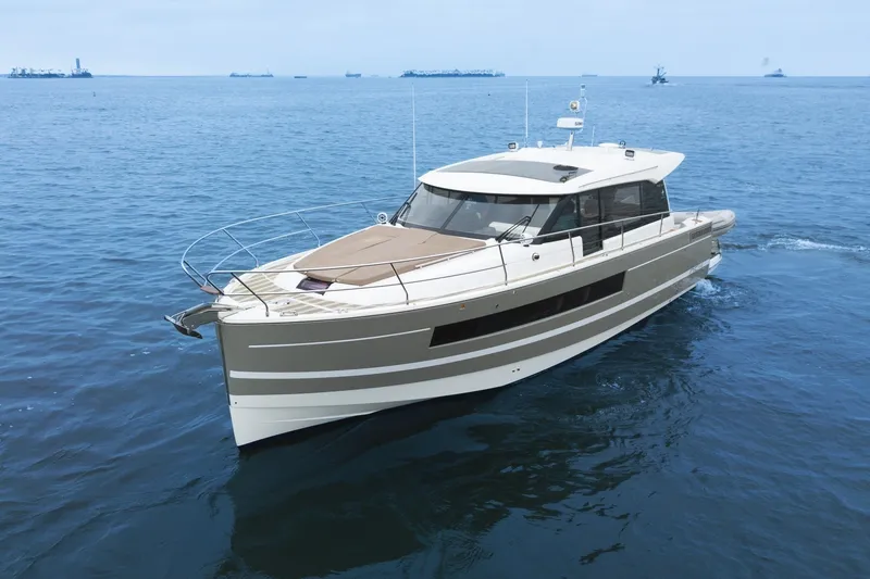 Slide: The Image of 2014 Jeanneau NC 14 yacht cruising on open water. - 1