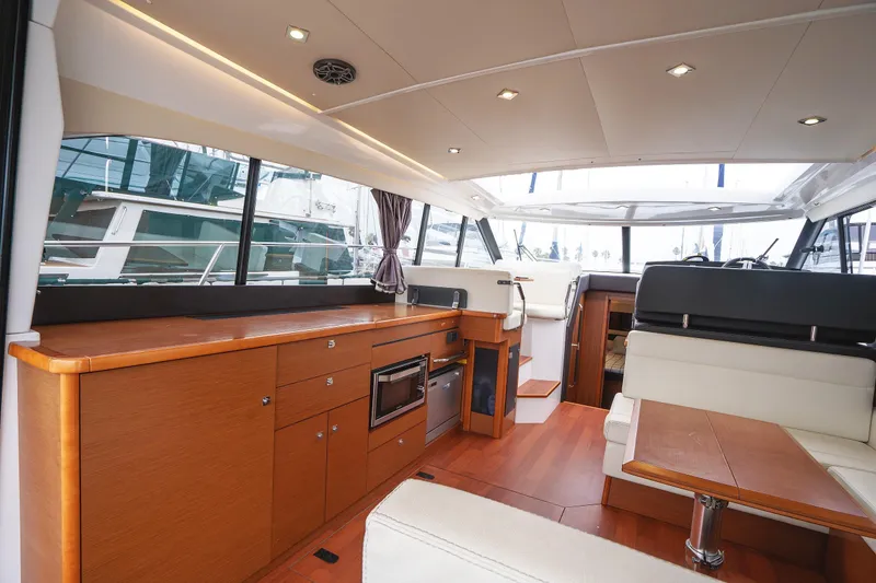Slide: The Image of Luxurious interior of 2014 Jeanneau NC 14 yacht with modern wood finishes and seating. - 12