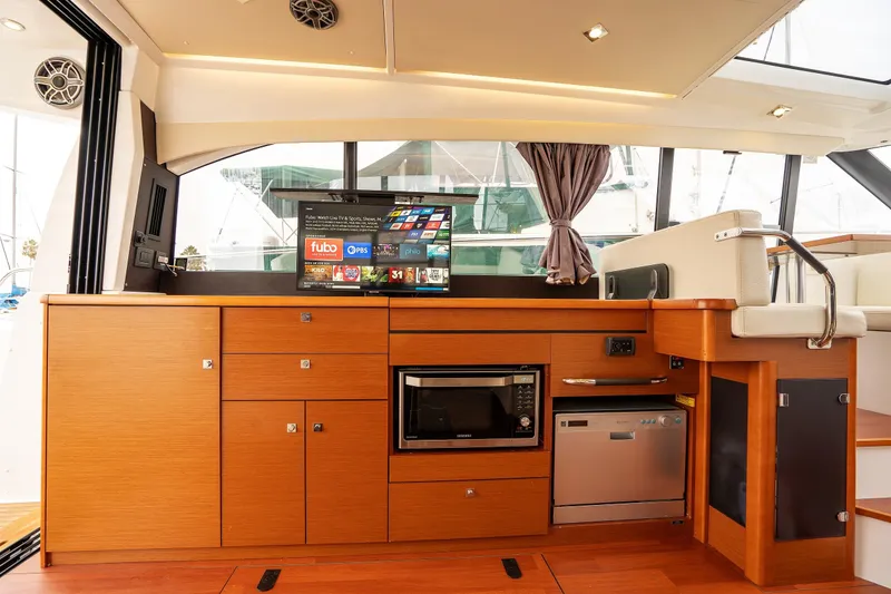Slide: The Image of Interior of 2014 Jeanneau NC 14 yacht with modern kitchen and entertainment system. - 15