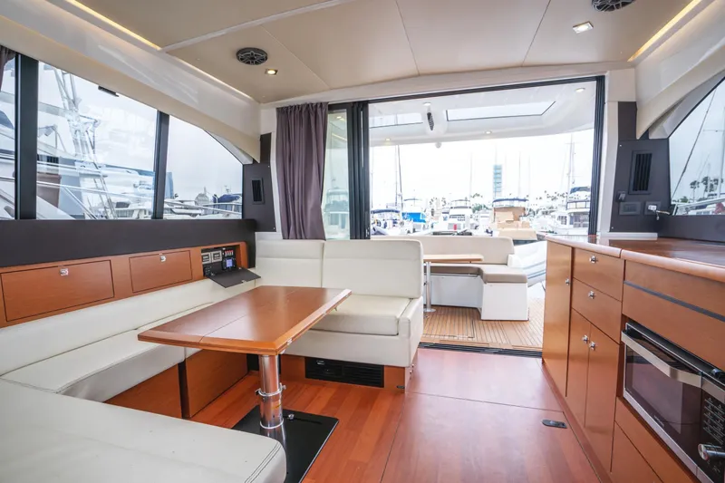 Slide: The Image of Interior of 2014 Jeanneau NC 14 yacht with modern seating and wood finishes. - 19