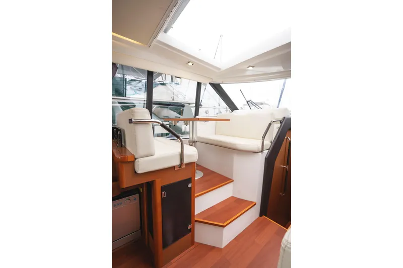 Slide: The Image of Interior of 2014 Jeanneau NC 14 yacht with wooden stairs and white seating. - 20