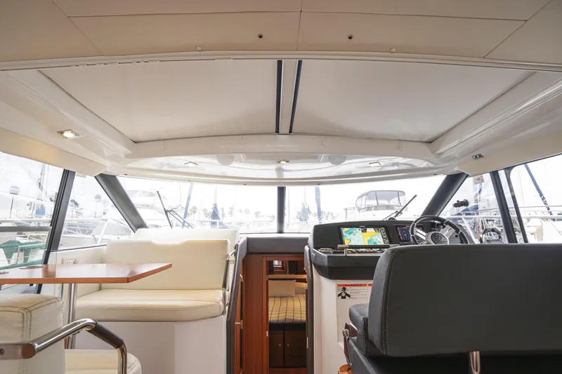 Slide: The Image of Interior of 2014 Jeanneau NC 14 yacht, featuring helm and seating area. - 22