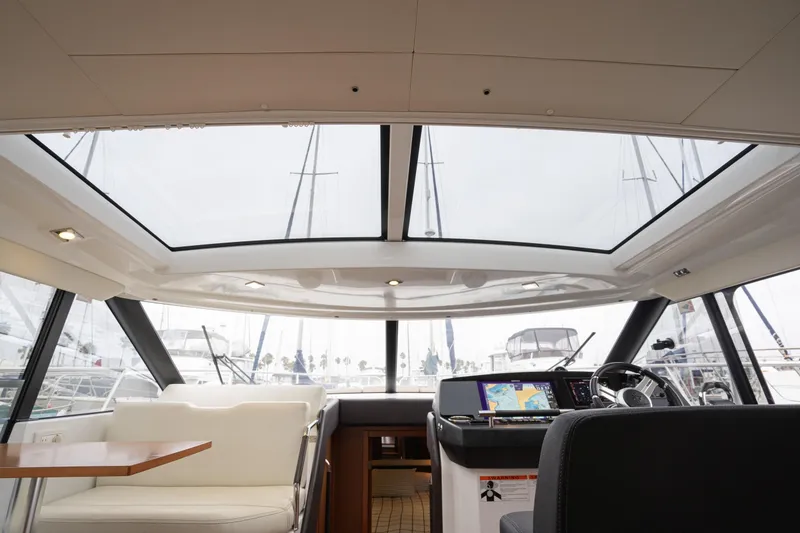 Slide: The Image of Interior view of 2014 Jeanneau NC 14 yacht with panoramic windows and modern helm. - 23