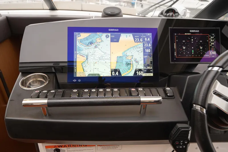 Slide: The Image of Control panel of a 2014 Jeanneau NC 14 boat with Simrad navigation system. - 28