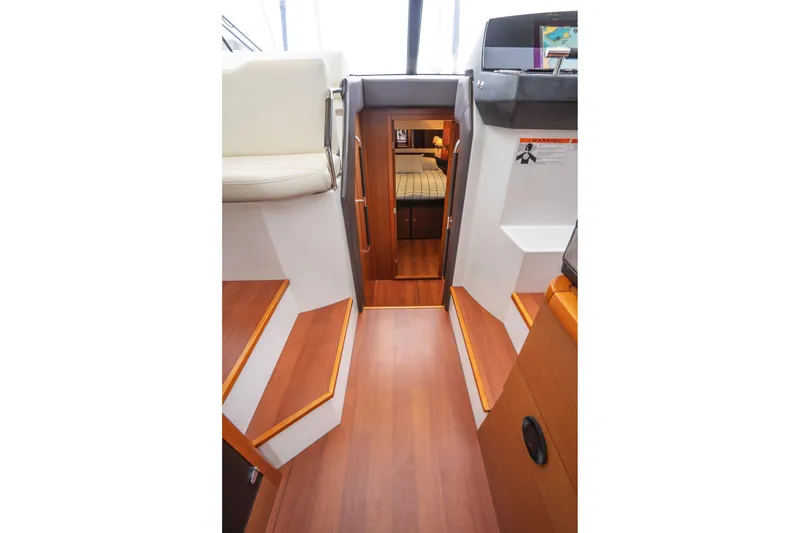 Slide: The Image of Interior view of 2014 Jeanneau NC 14 yacht with wooden flooring and cabin access. - 29