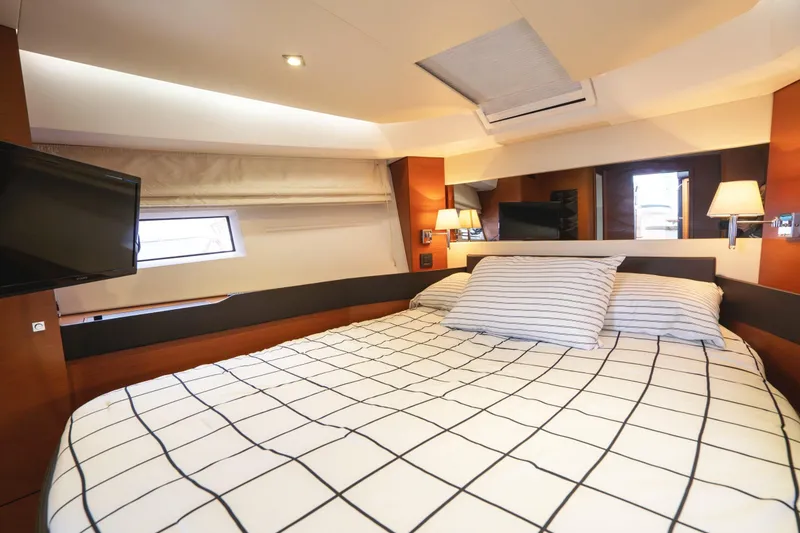 Slide: The Image of Luxurious cabin interior of 2014 Jeanneau NC 14 yacht with cozy bedding. - 33