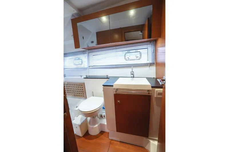 Slide: The Image of Bathroom interior of 2014 Jeanneau NC 14 yacht with modern fixtures and wooden accents. - 36