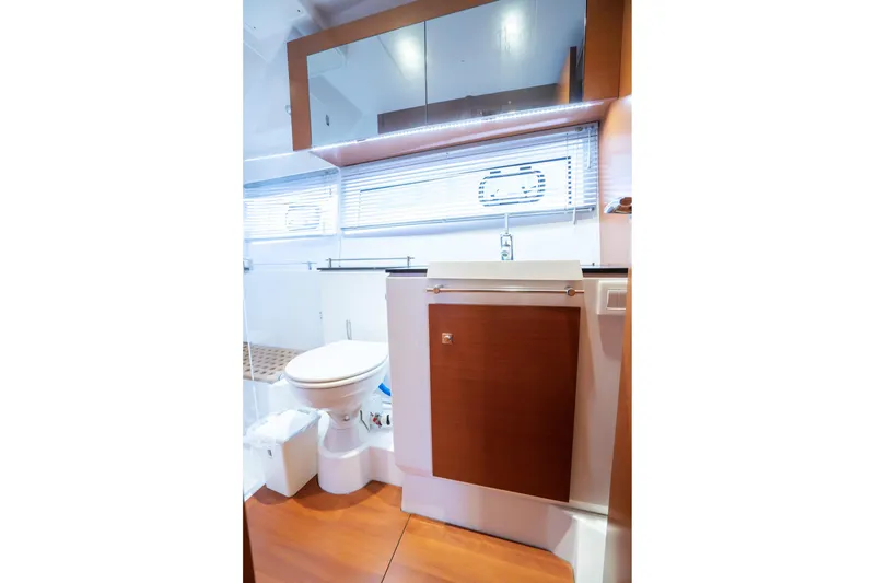 Slide: The Image of Bathroom interior of 2014 Jeanneau NC 14 yacht, featuring modern fixtures and wooden cabinetry. - 37