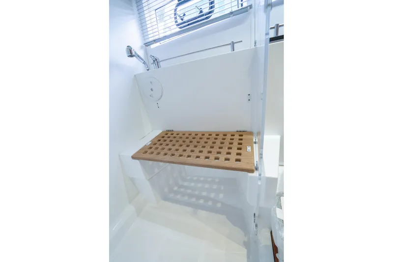 Slide: The Image of 2014 Jeanneau NC 14 yacht shower with wooden bench and modern fixtures. - 39
