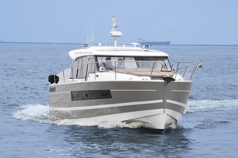 Slide: The Image of 2014 Jeanneau NC 14 yacht cruising on open water. - 4