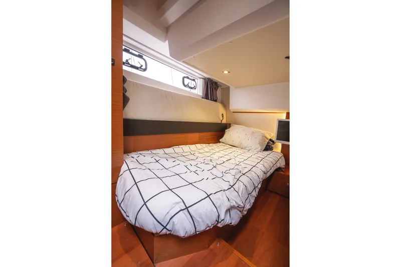Slide: The Image of Cozy bedroom interior of 2014 Jeanneau NC 14 yacht with modern bedding. - 41