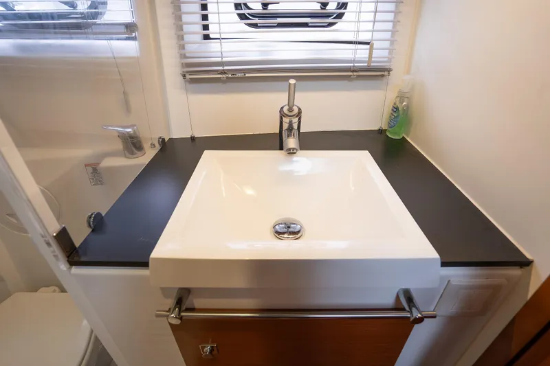 Slide: The Image of Modern bathroom sink in 2014 Jeanneau NC 14 yacht, featuring sleek design and chrome fixtures. - 43