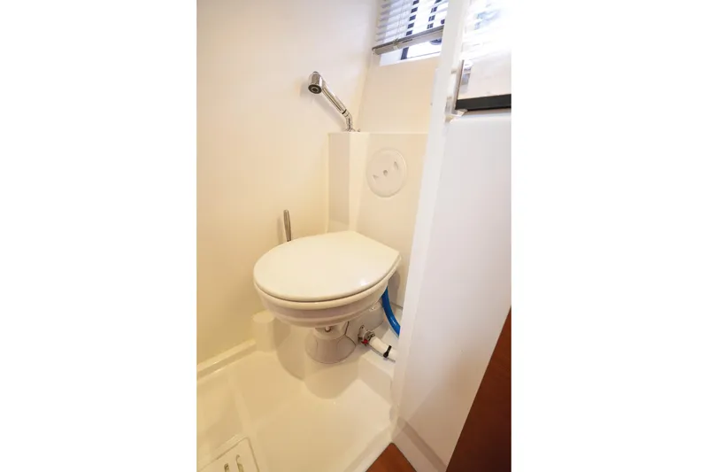 Slide: The Image of 2014 Jeanneau NC 14 yacht bathroom with compact toilet and shower. - 44