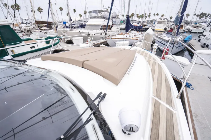 Slide: The Image of 2014 Jeanneau NC 14 yacht docked in a marina with palm trees. - 45