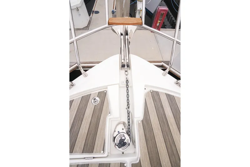 Slide: The Image of 2014 Jeanneau NC 14 boat deck with anchor chain and wooden flooring. - 47