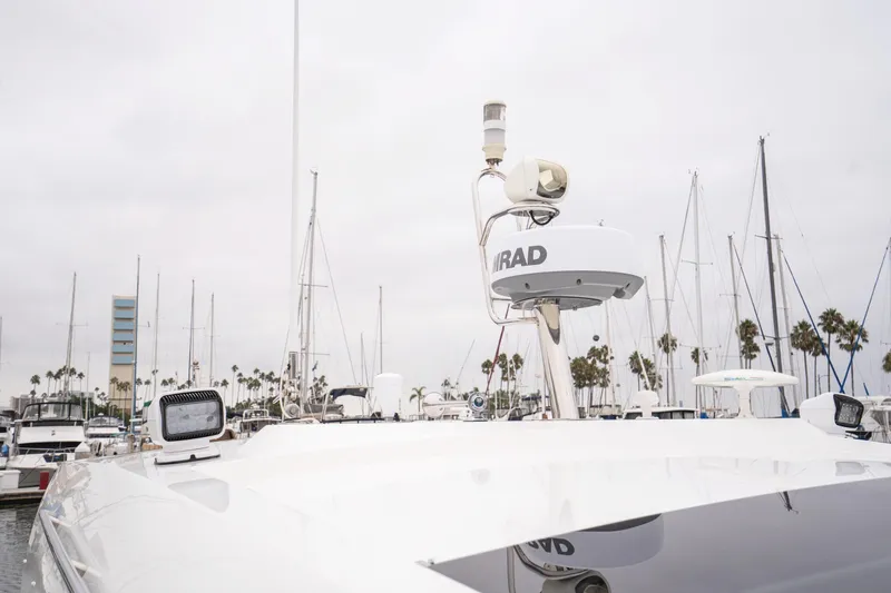 Slide: The Image of 2014 Jeanneau NC 14 yacht with radar, docked in a marina with sailboats. - 48