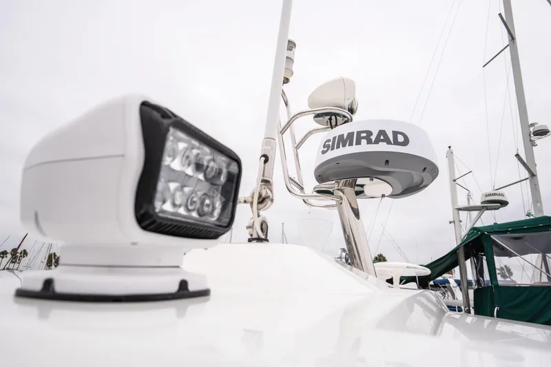 Slide: The Image of Radar and spotlight on 2014 Jeanneau NC 14 boat, featuring Simrad equipment. - 49