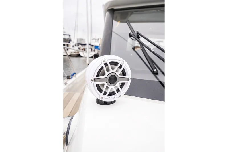 Slide: The Image of White speaker on 2014 Jeanneau NC 14 boat deck, near windshield wiper. - 50