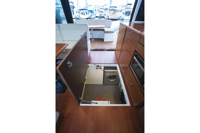 Slide: The Image of Interior of 2014 Jeanneau NC 14 yacht with open floor hatch revealing storage area. - 54