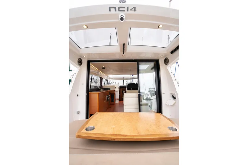Slide: The Image of 2014 Jeanneau NC 14 yacht interior with wooden table and modern design. - 9