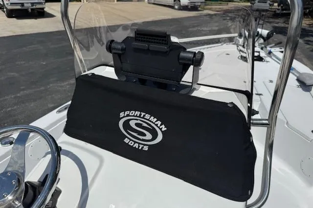 Slide: The Image of 2023 Sportsman Tournament 214 SBX Bay Boat console with steering wheel and branded cover. - 11