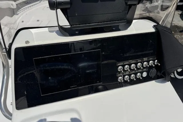 Slide: The Image of 2023 Sportsman Tournament 214 SBX Bay Boat dashboard with control panel and display screen. - 12