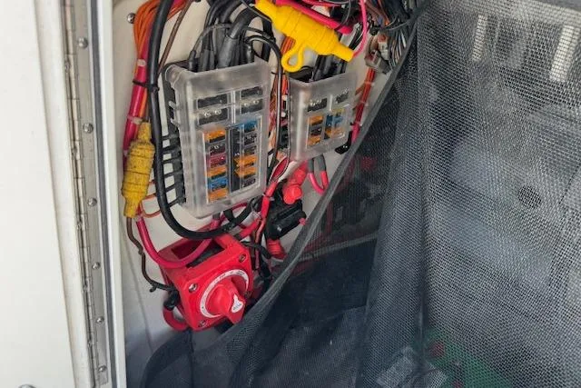 Slide: The Image of Electrical wiring and fuse panel inside a 2023 Sportsman Tournament 214 SBX Bay Boat. - 13