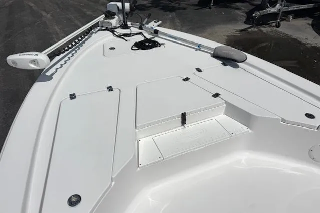 Slide: The Image of 2023 Sportsman Tournament 214 SBX Bay Boat deck with storage compartments and trolling motor. - 14
