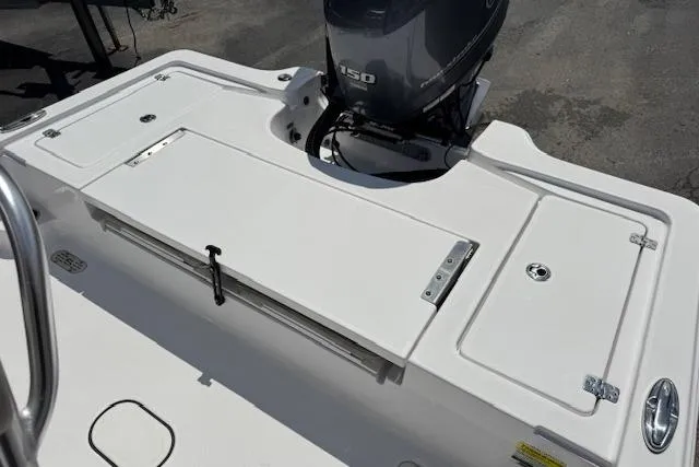 Slide: The Image of 2023 Sportsman Tournament 214 SBX Bay Boat deck with storage compartments and outboard motor. - 16