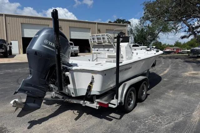 Slide: The Image of 2023 Sportsman Tournament 214 SBX Bay Boat on trailer, parked outdoors. - 2