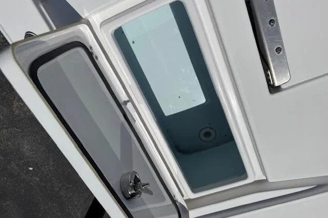Slide: The Image of 2023 Sportsman Tournament 214 SBX Bay Boat livewell compartment, open lid, stainless steel latch. - 22