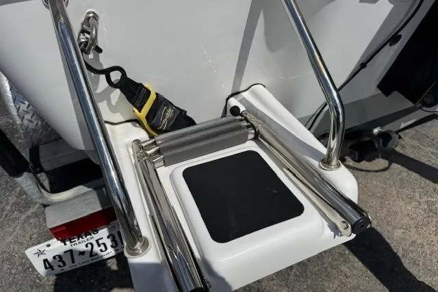 Slide: The Image of 2023 Sportsman Tournament 214 SBX Bay Boat with foldable ladder and Texas license plate. - 23