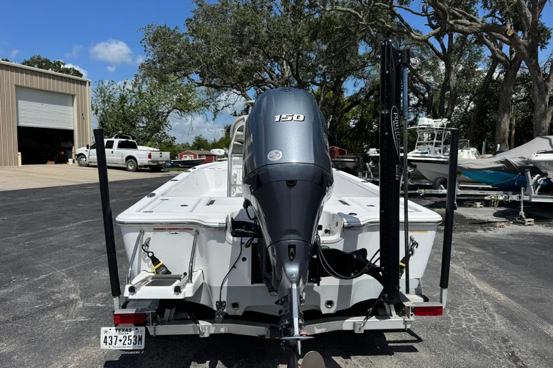 Slide: The Image of 2023 Sportsman Tournament 214 SBX Bay Boat with 150 HP engine, parked outdoors. - 4