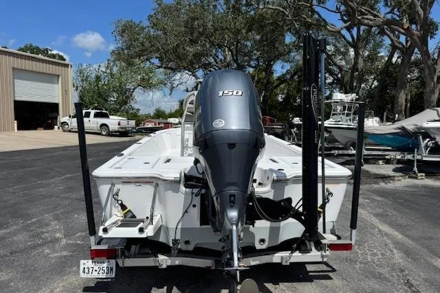 Slide: The Image of 2023 Sportsman Tournament 214 SBX Bay Boat with 150 HP engine, parked outdoors. - 7